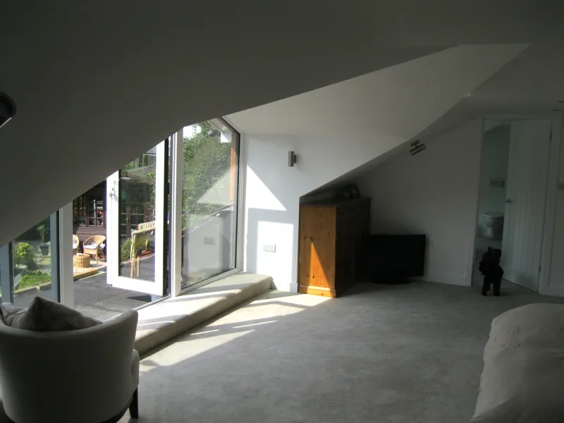 Loft conversion interior with large dormer window